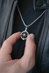 Close up of men's silver ashes urn pendant held in hand stainless steel