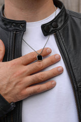 Men's black onyx square pendant necklace worn with leather jacket stainless steel