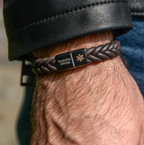 Close up of men's engraved medical alert bracelet on wrist stainless steel