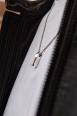 Men's personalised bar necklace worn on model light background stainless steel