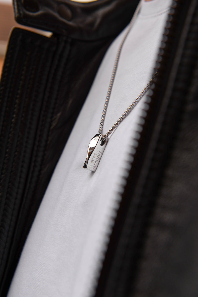 Men's personalised bar necklace worn on model light background stainless steel