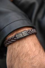 Men's personalised braided leather bracelet with engraved daddy clasp worn on wrist