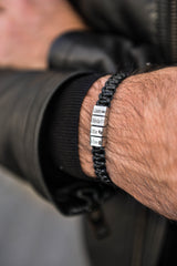 Men's personalised woven leather bracelet with engraved bead worn on wrist