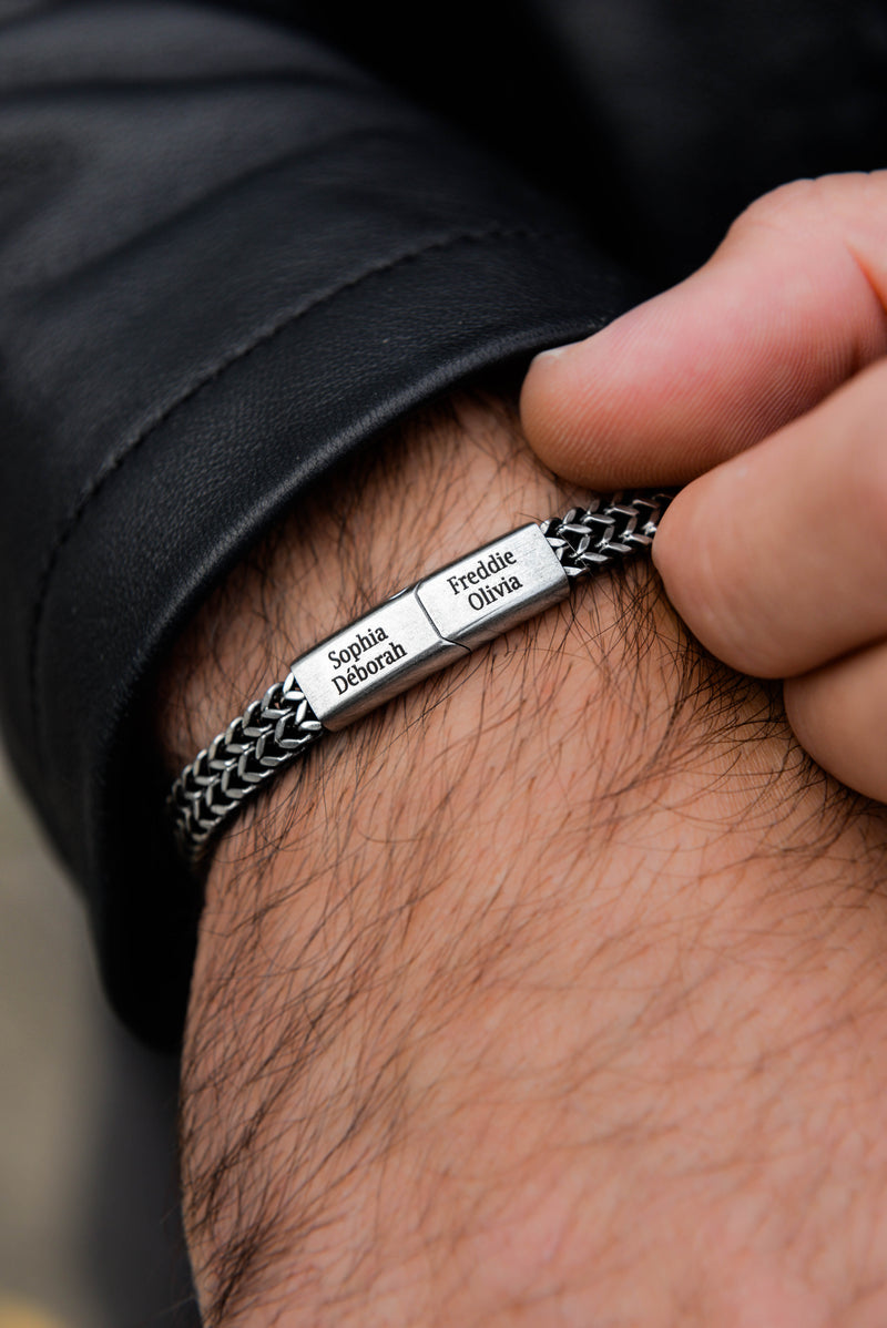 Close up of men's silver curb chain bracelet clasp detail stainless steel