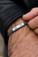 Men's silver curb chain bracelet flat lay stainless steel tarnish-free