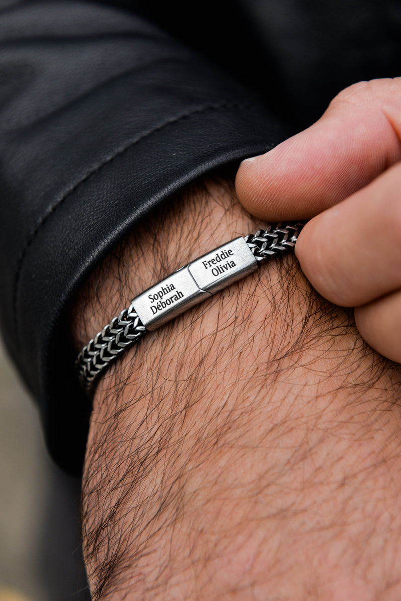 Men's silver curb chain bracelet flat lay stainless steel tarnish-free