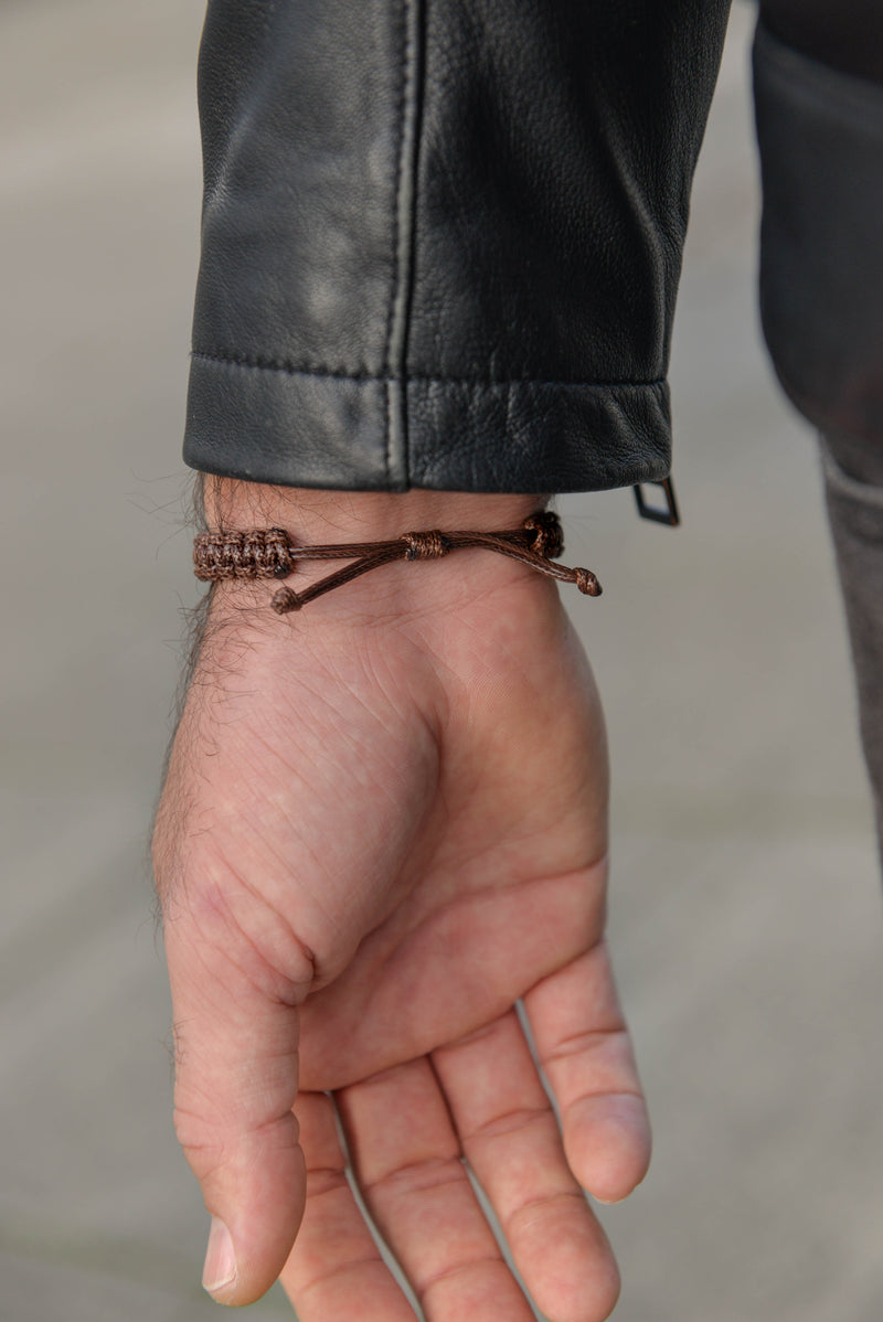 Men's adjustable woven leather bracelet close up hand view
